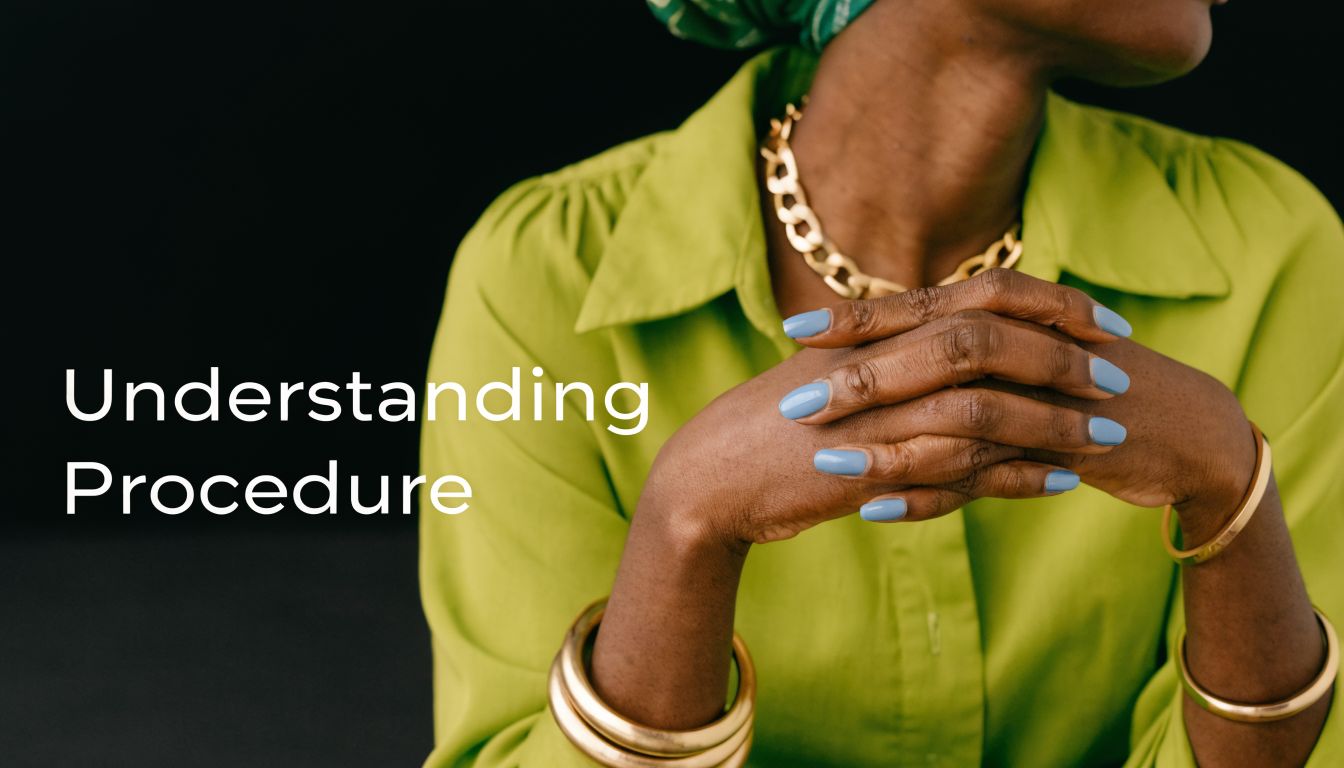 A professional woman with her hands clasped, wearing a lime green top and gold jewelry.